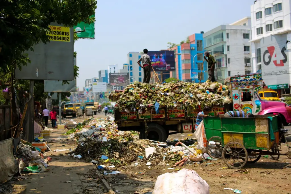 What Happens Inside a Landfill? The - Trash-filled streets with vibrant urban buildings in Bangladesh.